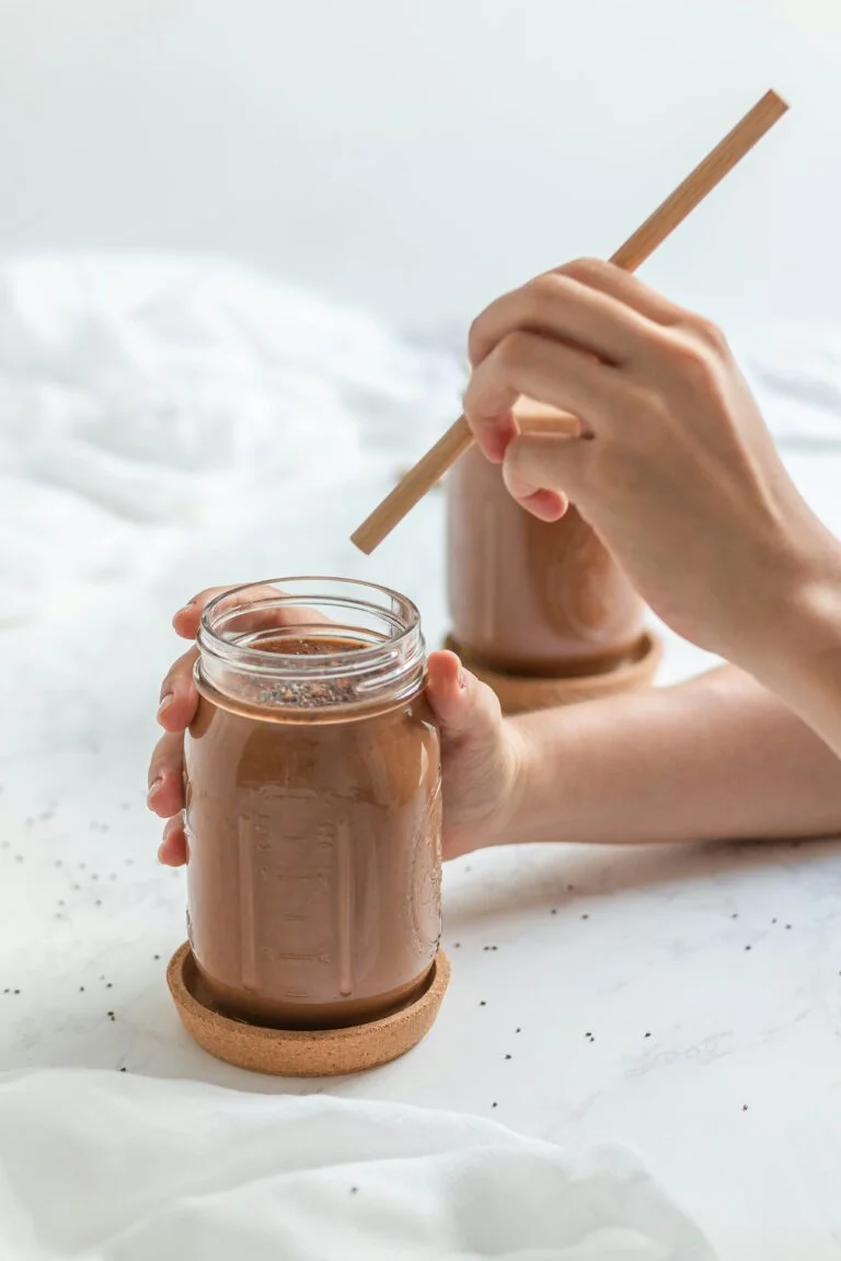 a person holding a reishi mushroom drink
