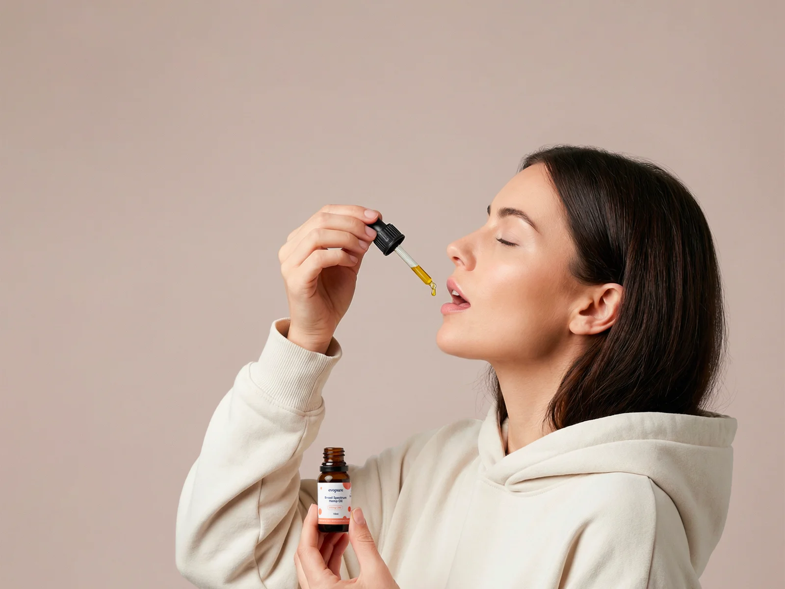 A woman taking evopure cbd oil