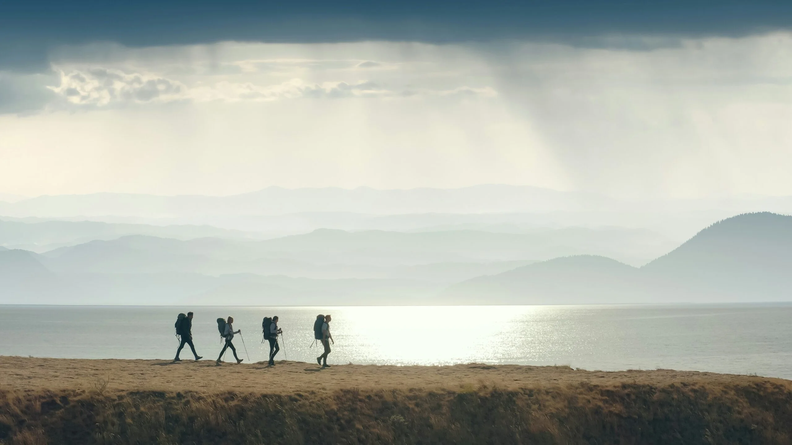 A group of people walking to the mountain