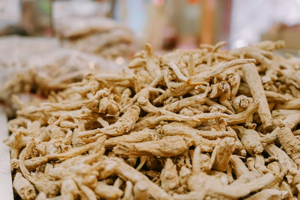 A pile of dried ginseng roots at a market stall