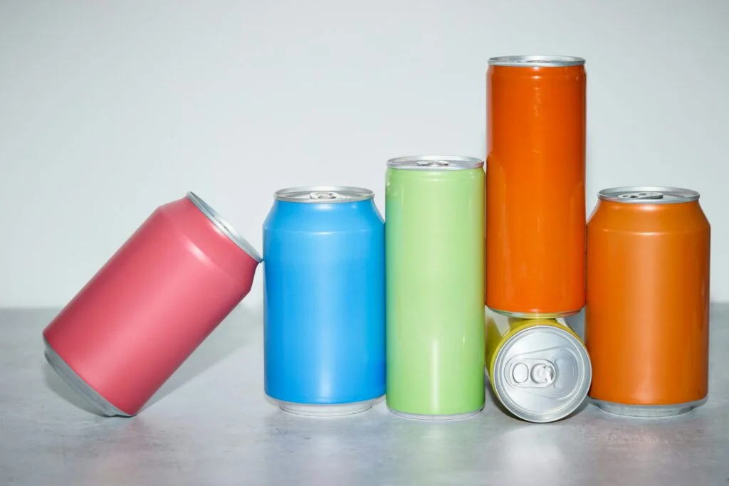 Colourful unbranded drink cans lined up on a table