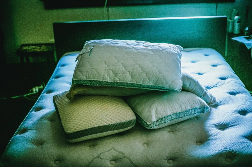 Pillows on a bed in a dimly lit bedroom