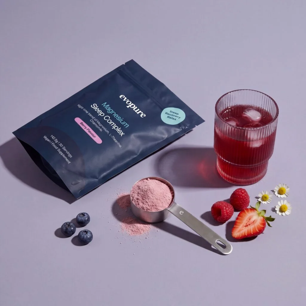 Evopure Magnesium Sleep Complex pouch with a scoop of berry powder and an iced berry magnesium drink