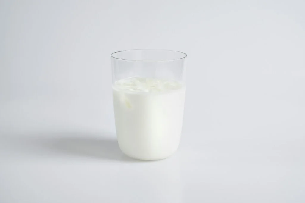 A glass of milk on a plain white background