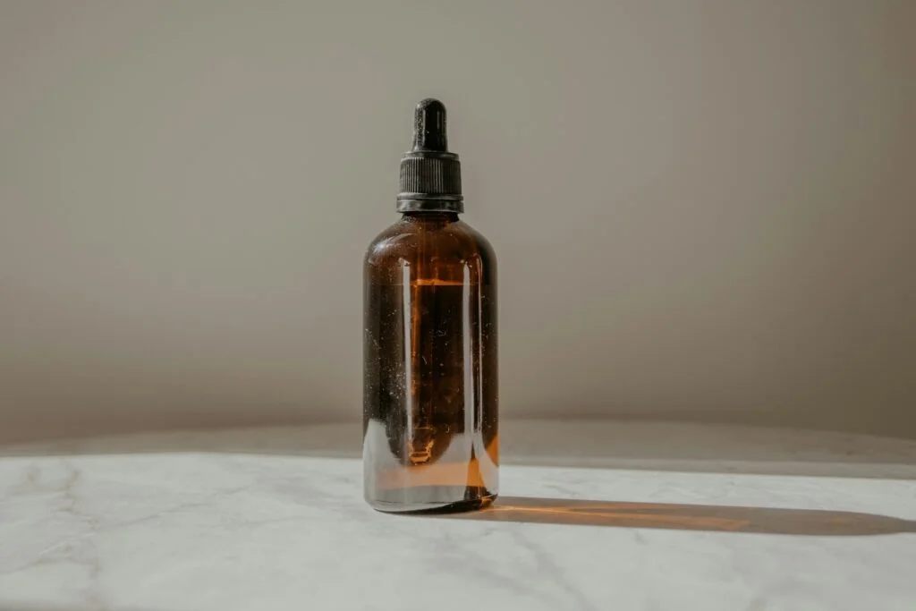 Amber dropper bottle on a marble surface
