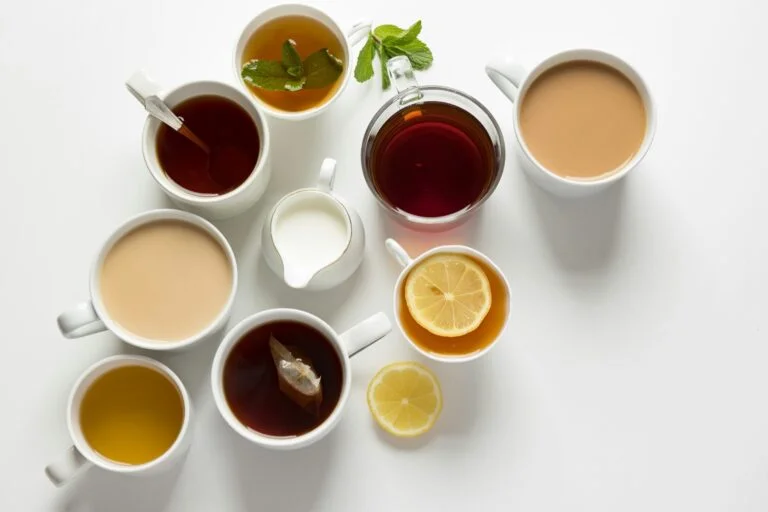 Cups of different teas and hot drinks seen from above