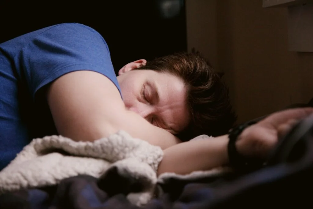Man in a deep sleep in a dimly lit bedroom
