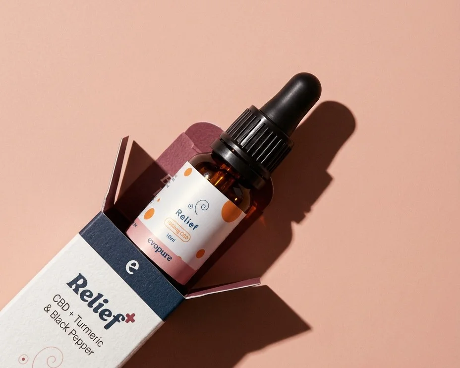 Evopure Relief+ CBD oil with turmeric and black pepper, sliding out of its box
