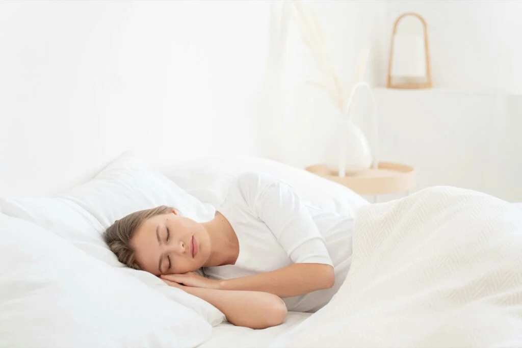 A woman lying in bed in her bedroom