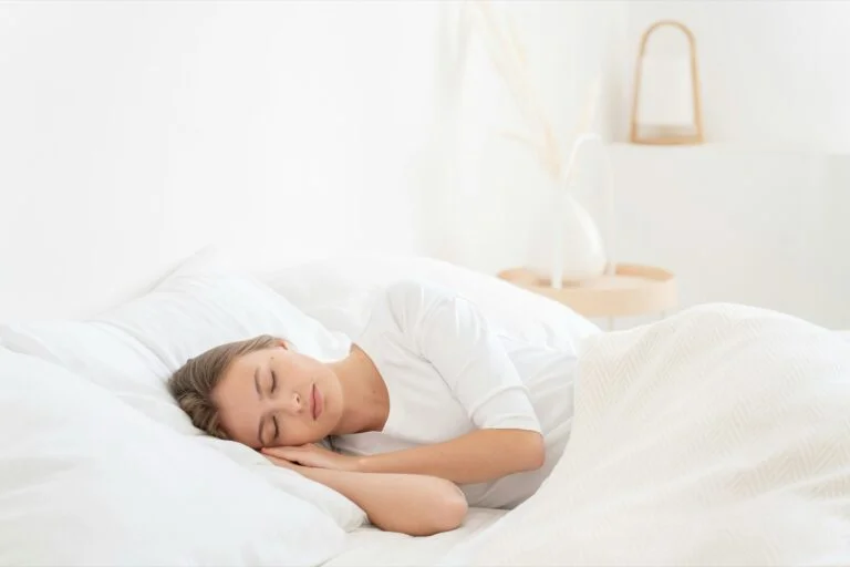 A woman lying in bed in her bedroom