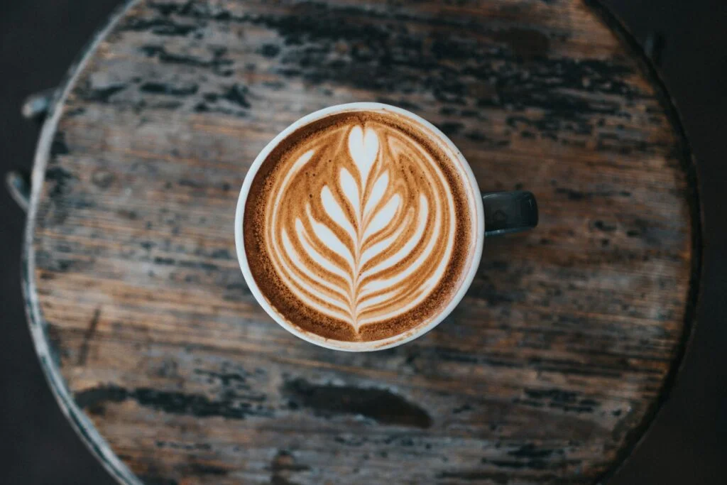 Cappuccino with latte art on a wooden table