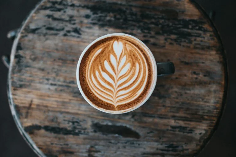 Cappuccino with latte art on a wooden table
