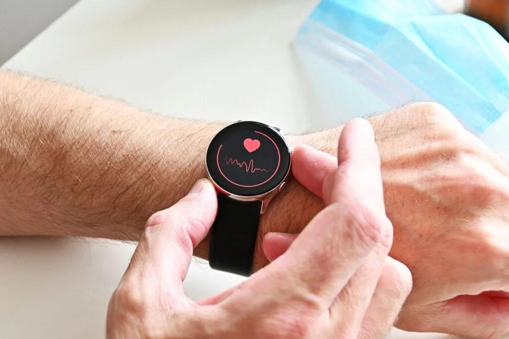 A person checking their heart rate on a smartwatch