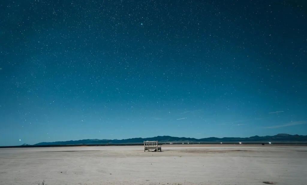 Starry night sky over a quiet desert landscape