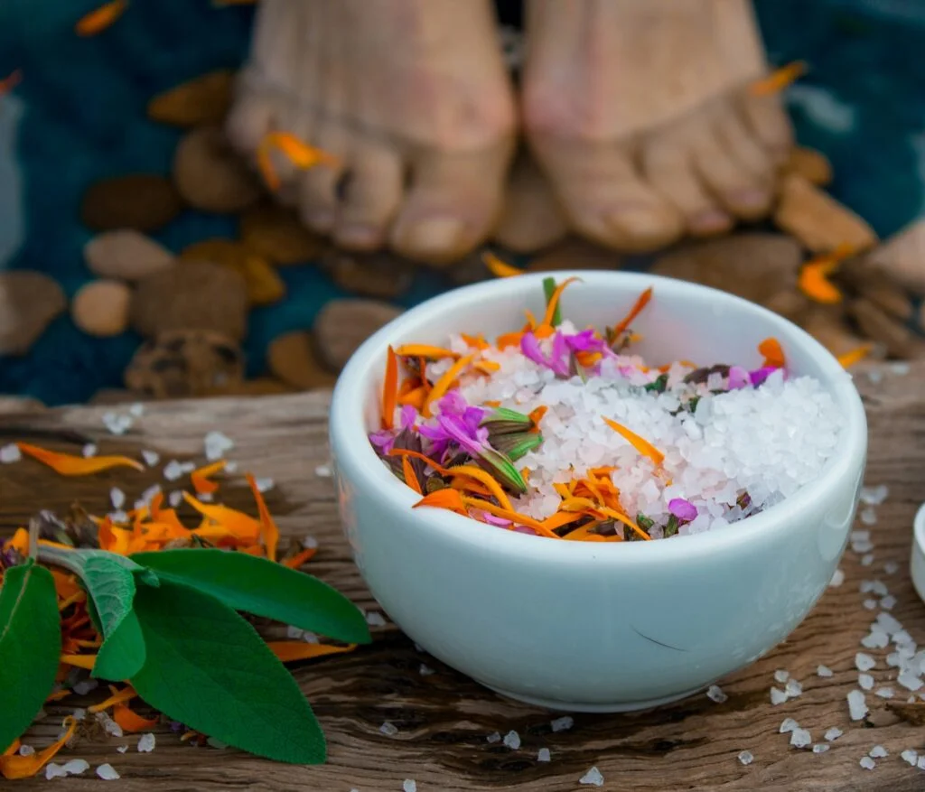Bowl of mineral bath salts with dried flower petals