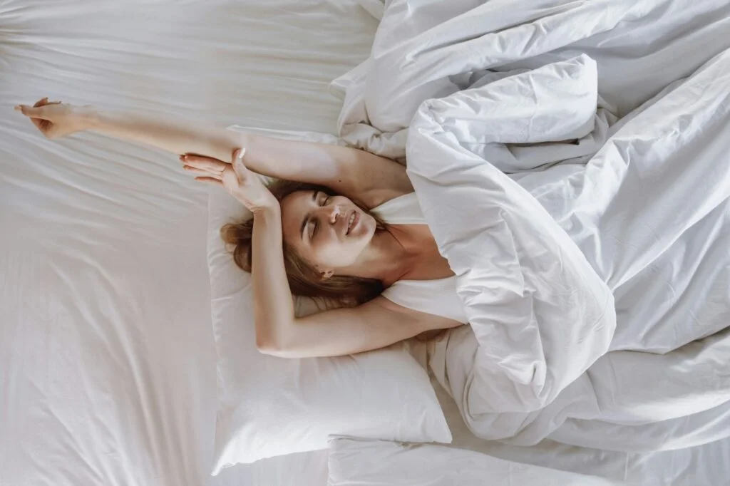 A woman relaxing in bed on a cosy morning
