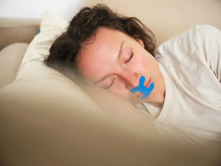 A woman lying down with tape over her mouth