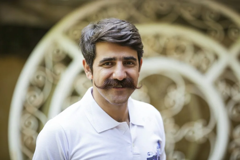 Smiling man with a full moustache