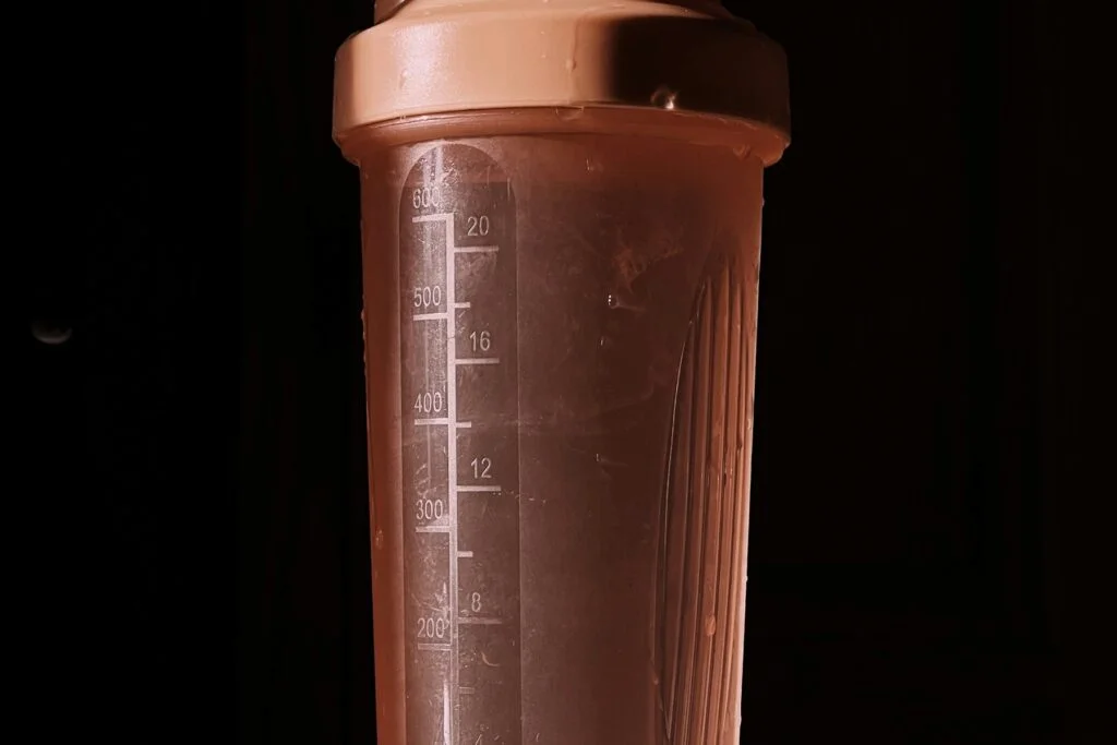Protein shaker bottle against a dark background