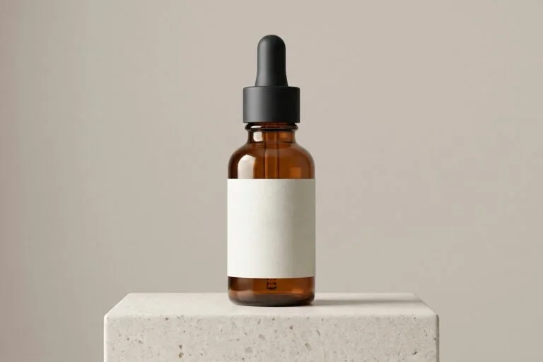Amber dropper bottle with a blank label on a stone block