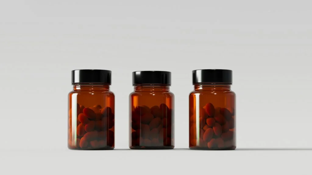 A plain supplement bottle on a cream background