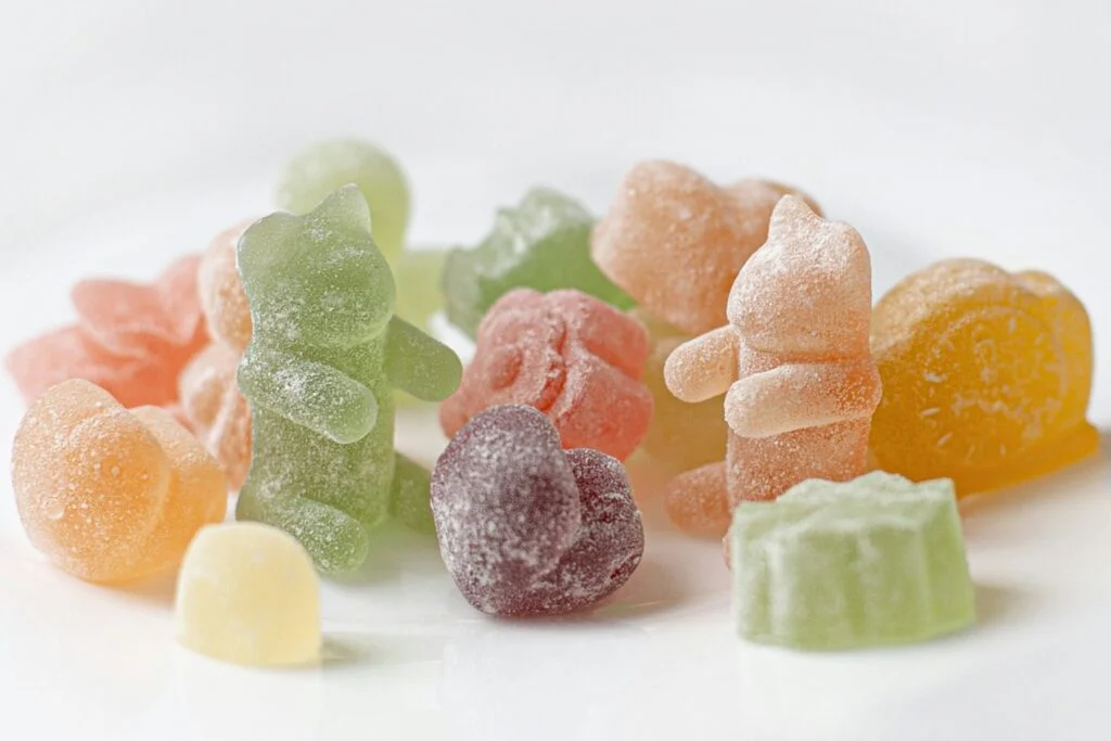 Assorted fruit gummies on a white plate
