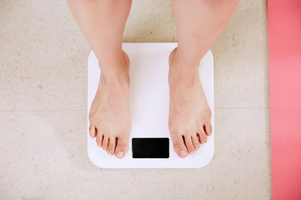 Bare feet on a white bathroom scale