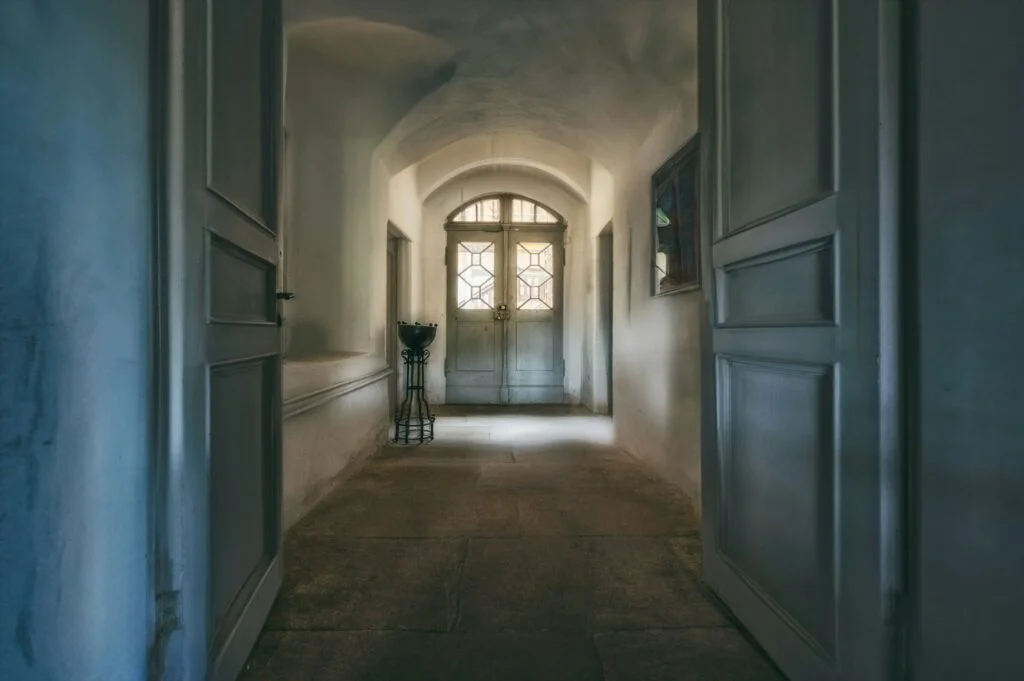 Dim hallway at night with open doors
