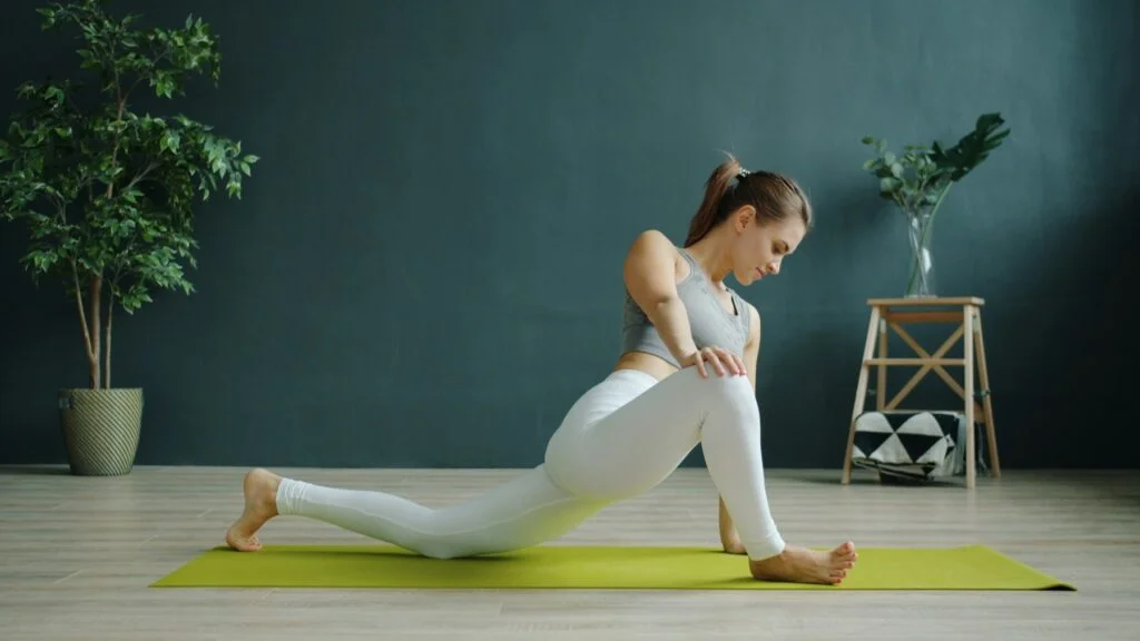 A woman stretching on a yoga mat at home