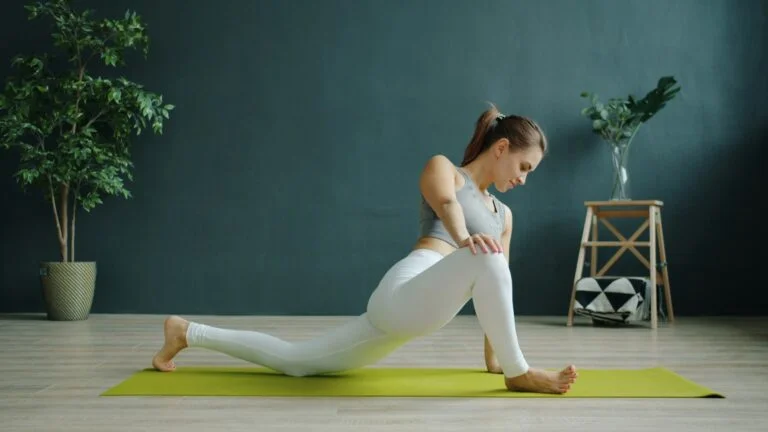 A woman stretching on a yoga mat at home