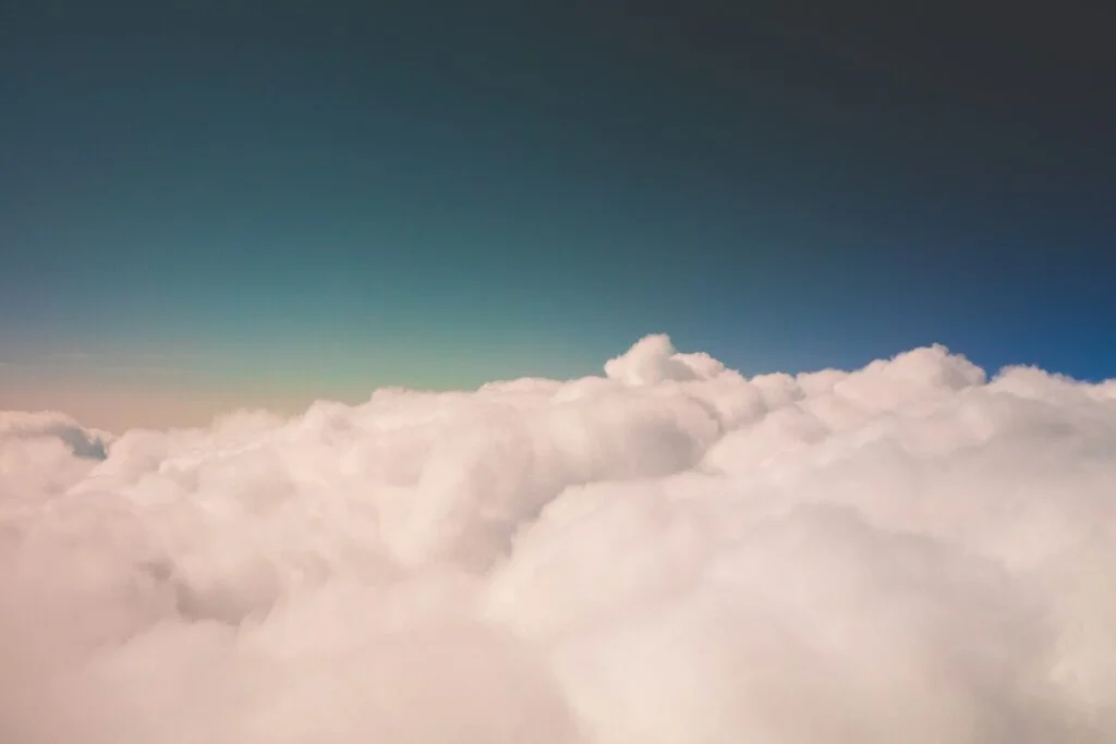 A soft sea of clouds under a deep blue sky