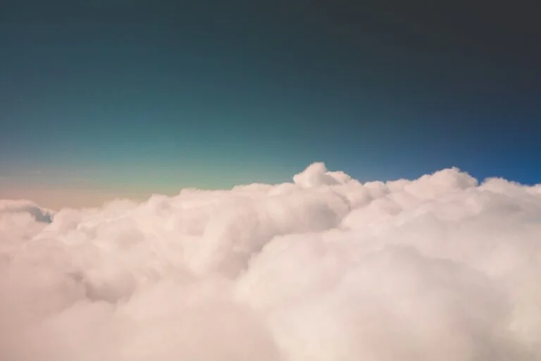 A soft sea of clouds under a deep blue sky