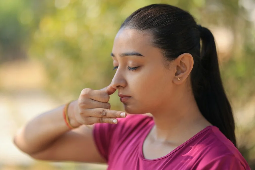 Young woman practising a breathing exercise outdoors