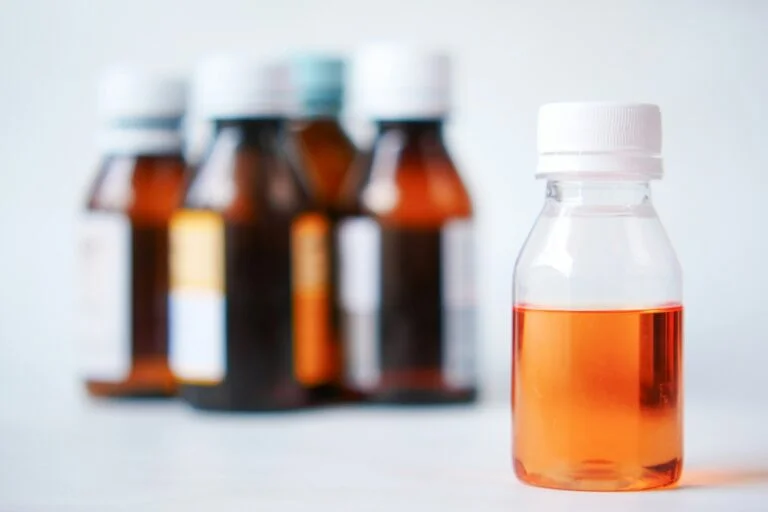 Small bottles of liquid supplement on a white table