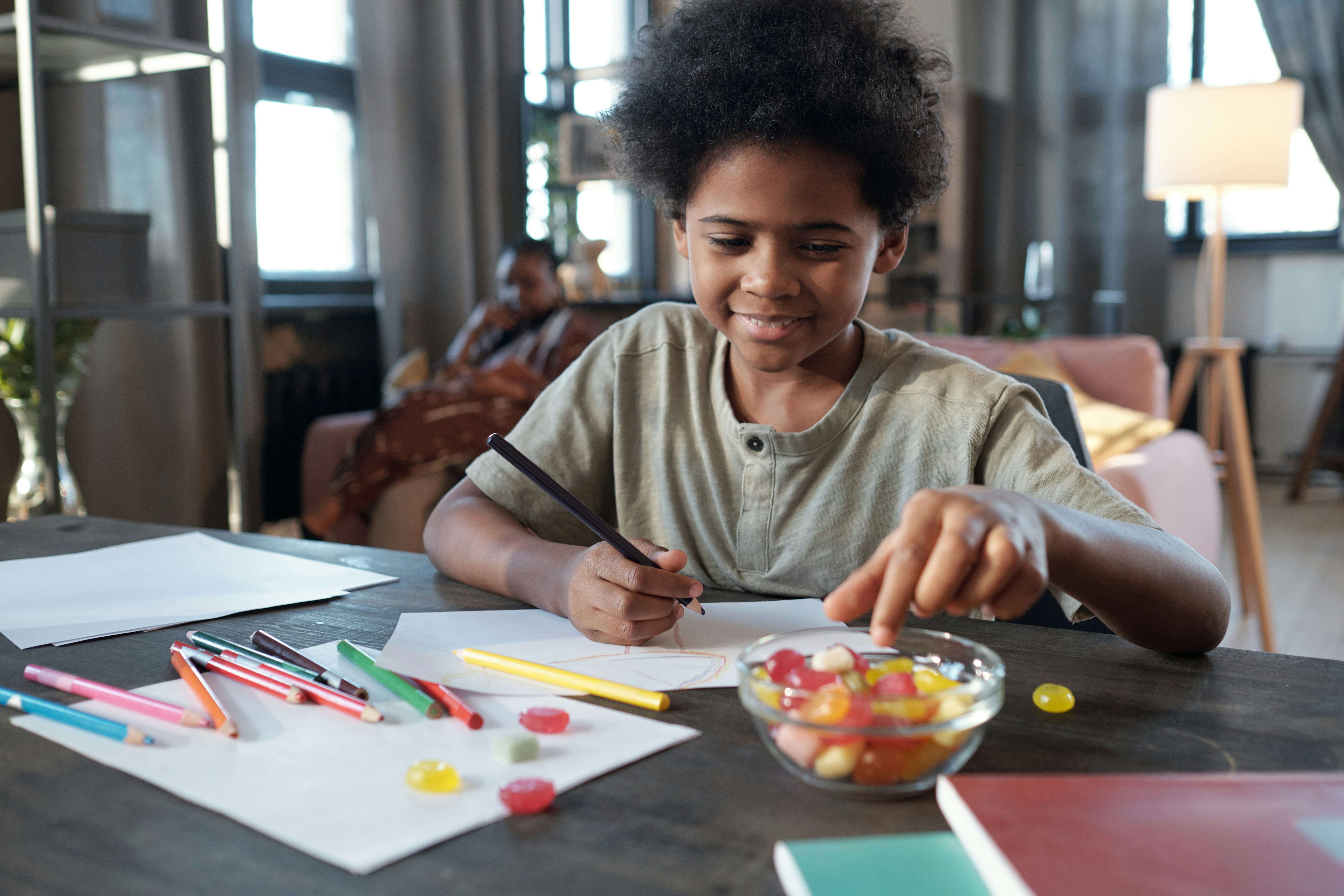 Schoolboy sitting at a table with magnesium gummies