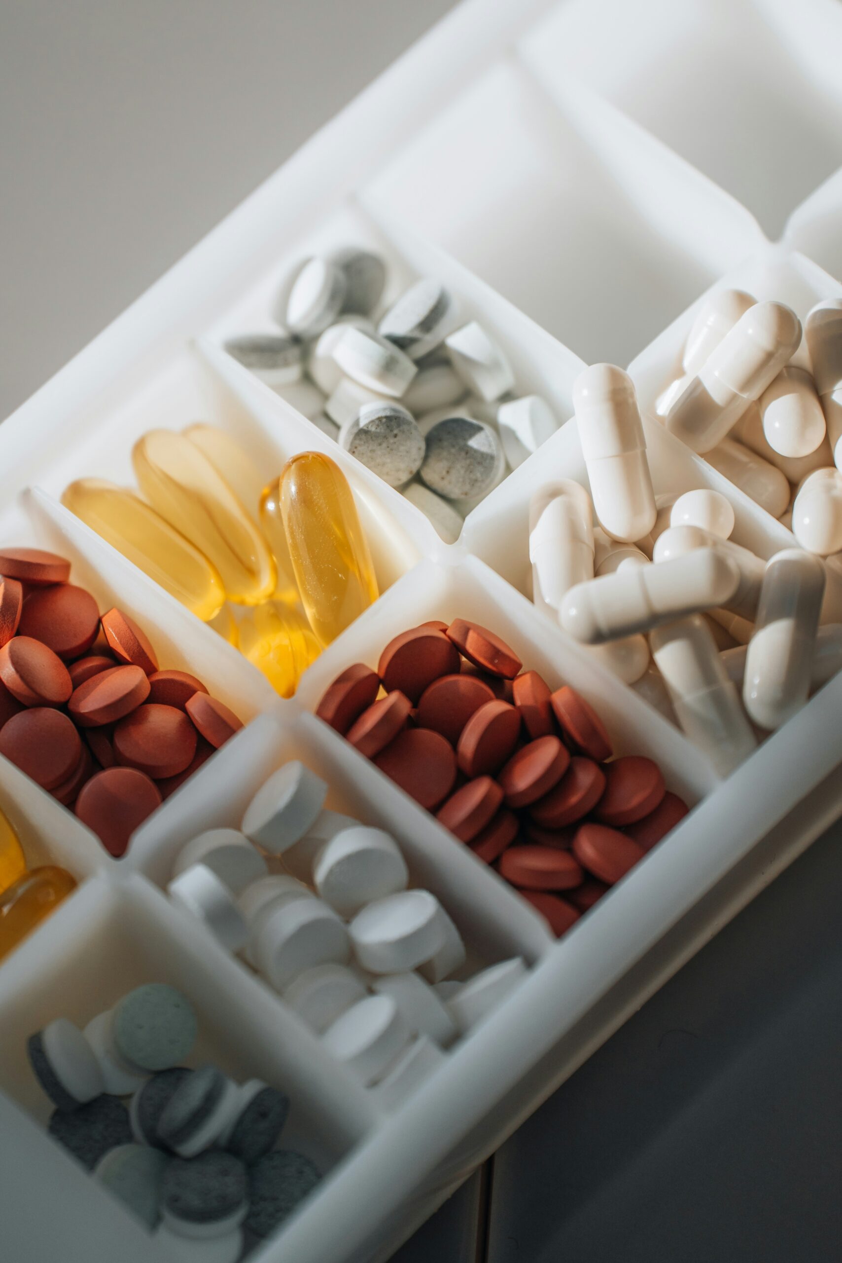 Pill box filled with different pills and capsules