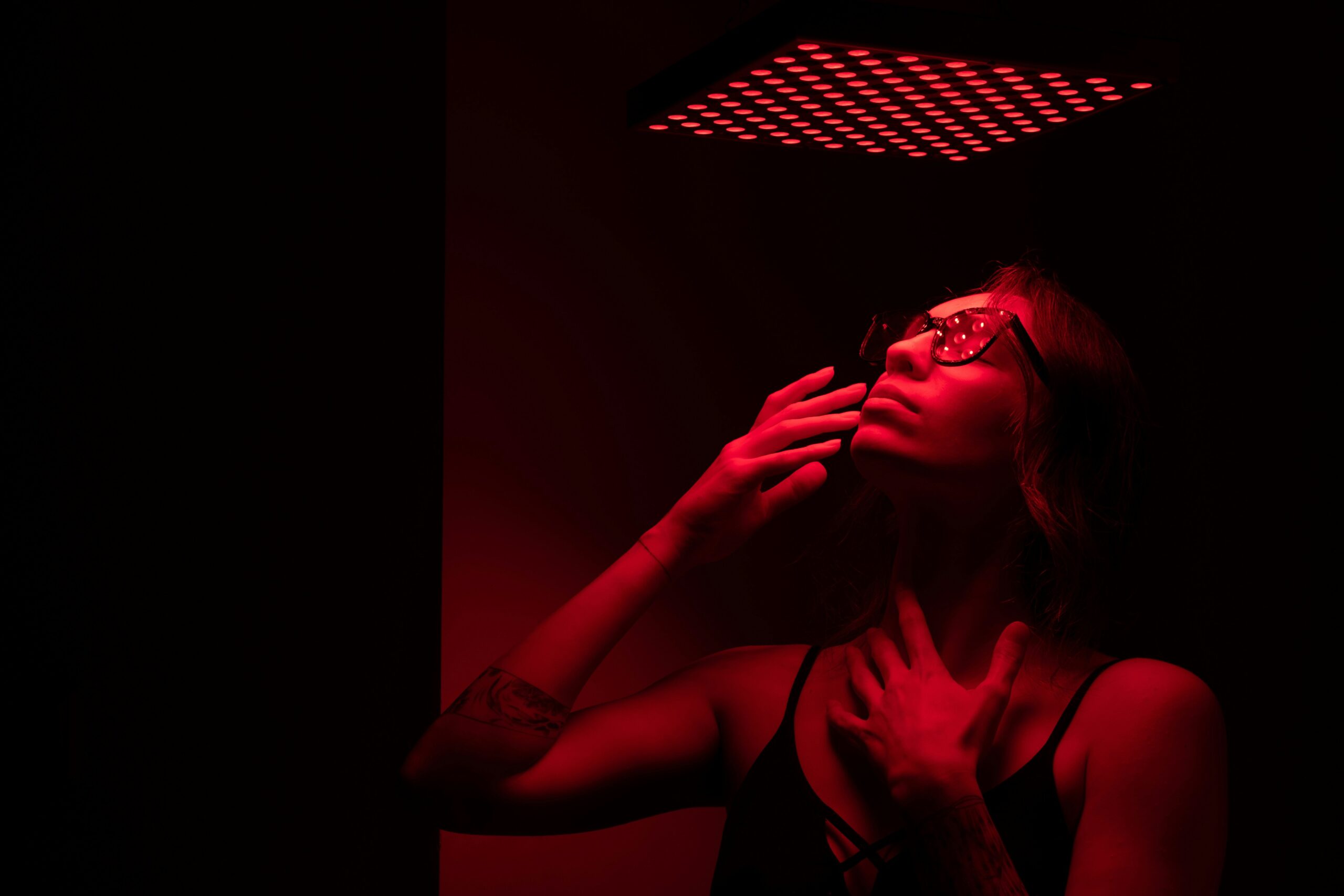 A woman in a dark room with red light