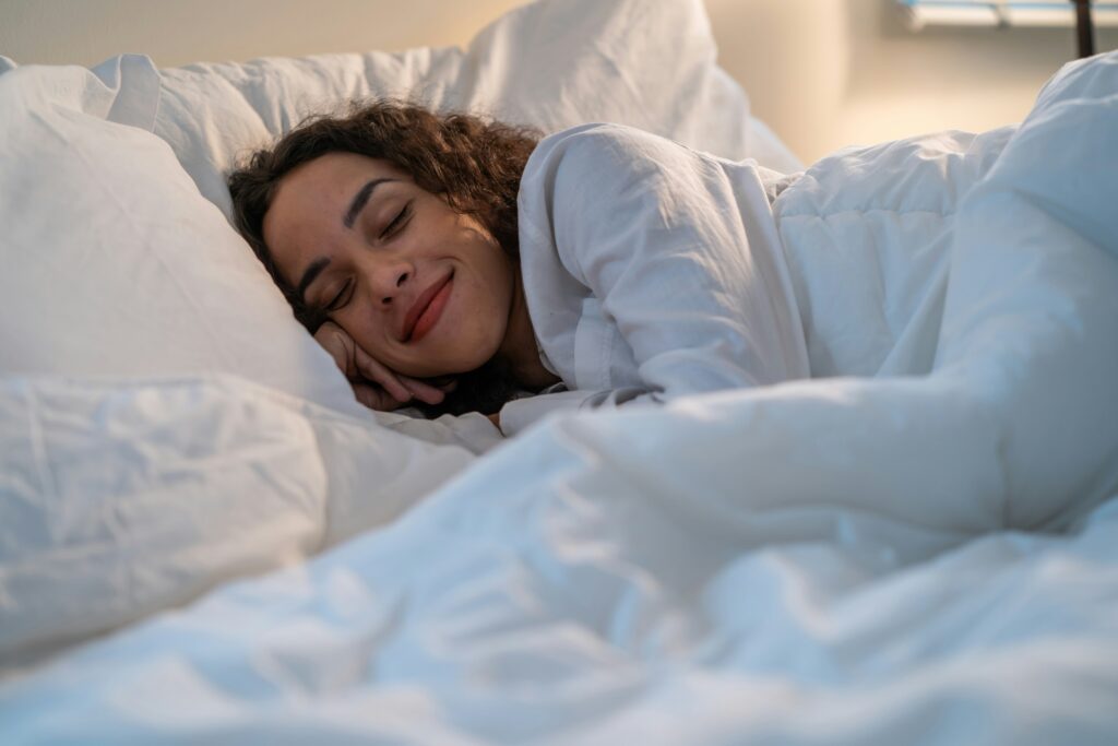 A woman with curly hair sleeping peacefully