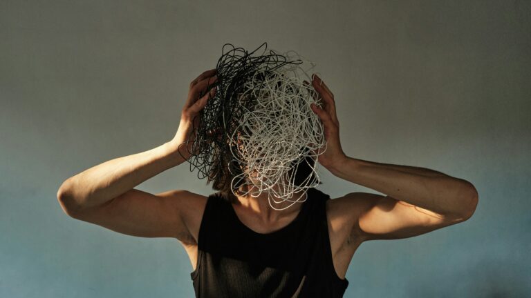 a man is holding his hands on head