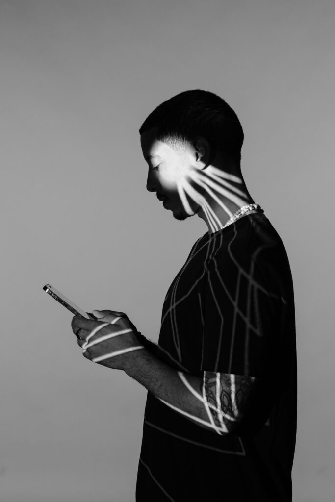 a man with his face painted like a skeleton holding phone