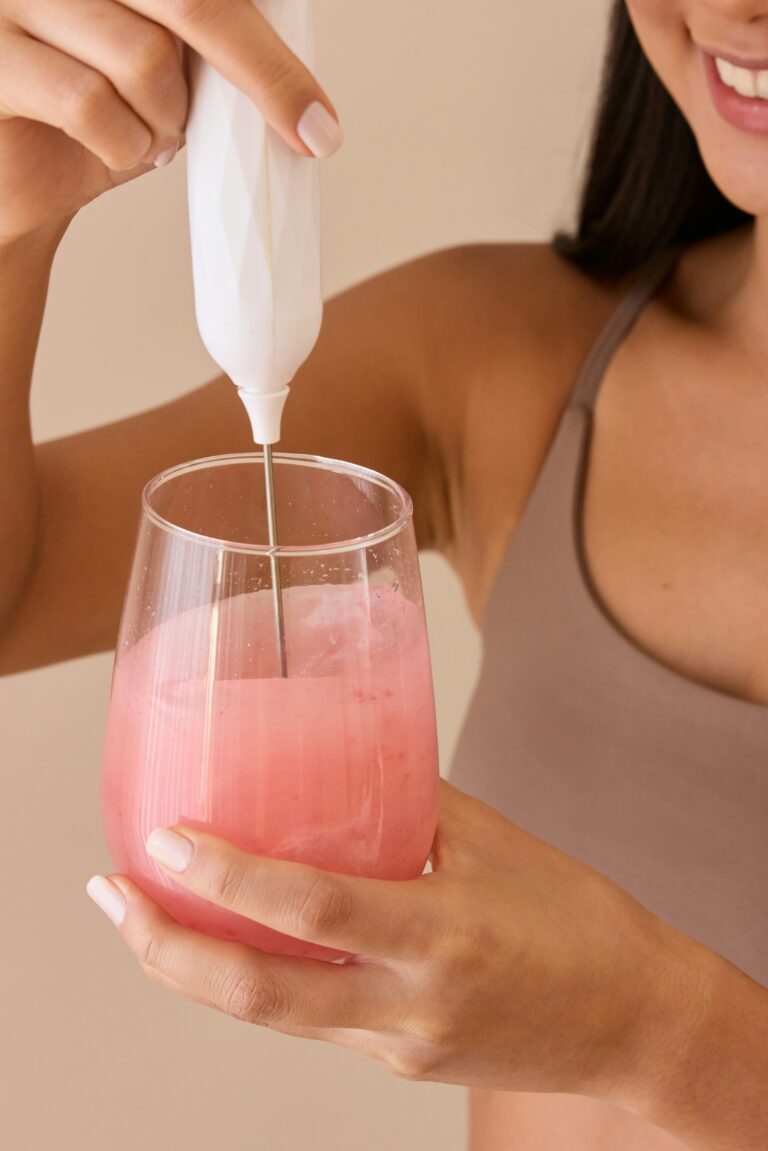 a woman holding magnesium drink in hand