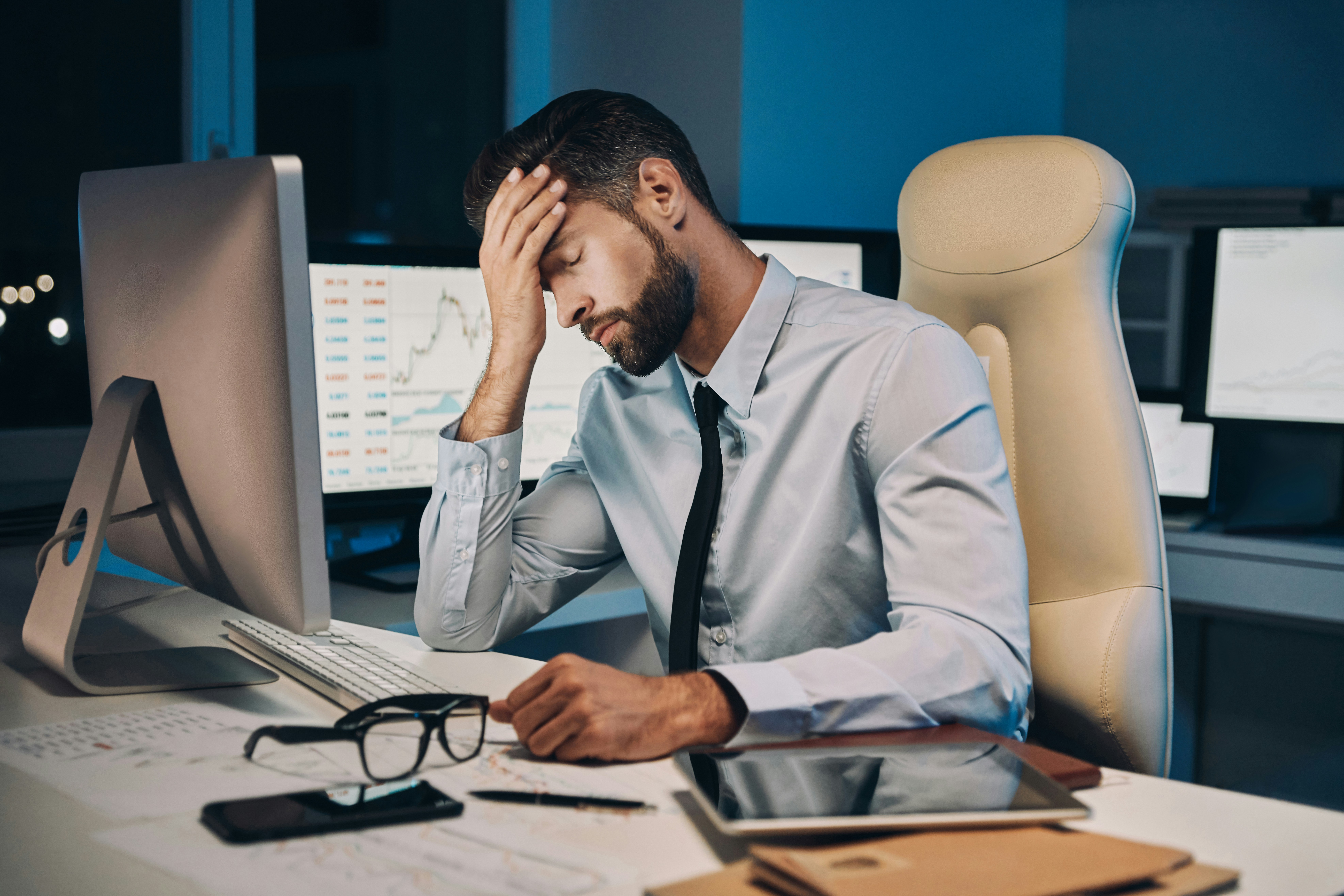 frustrated man with tie in the office