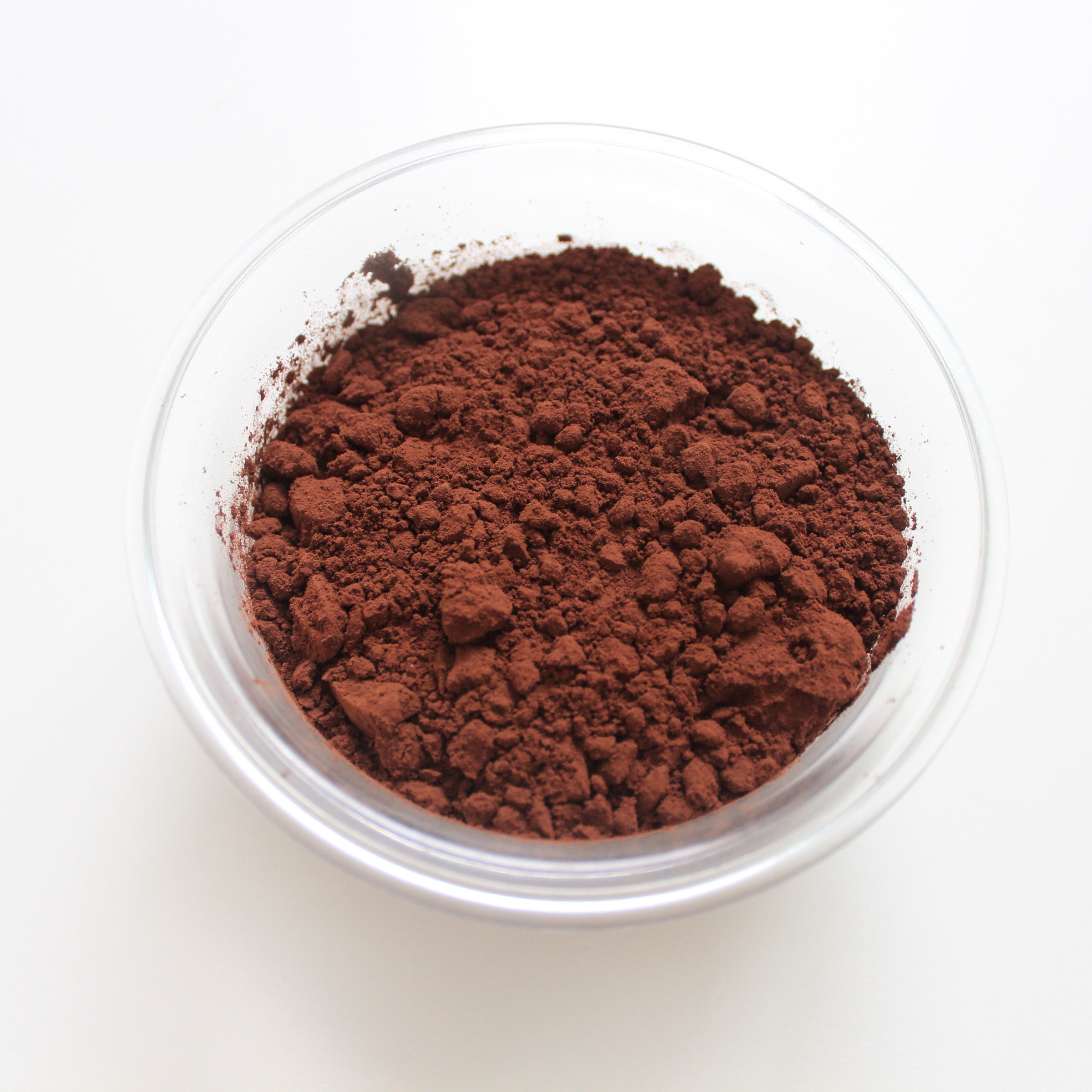 A glass bowl of cacao powder